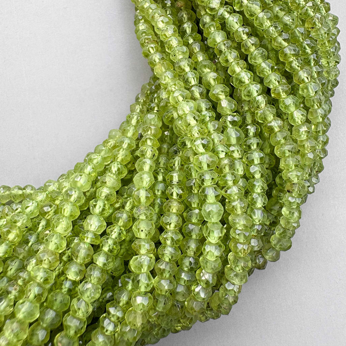 Natural peridot 3.5–4mm faceted beads on a 13-inch strand
